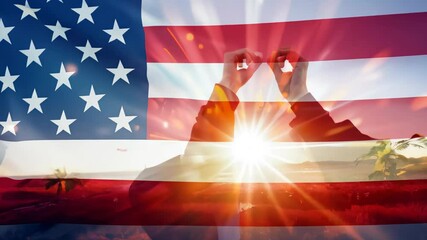 person forming a heart shape with their hands in front of the American flag, symbolizing love, unity and patriotism