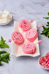 Jelly candies made of colored jelly and white marshmallow, twisted into a roll, on a light plate on a light background. Sweets, gifts.