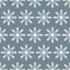 Seamless pattern of white snowflakes on a gray background