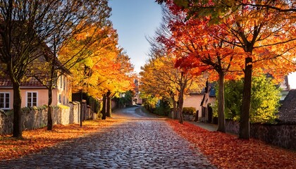 Naklejka premium Village street lined with trees in full autumn splendor, their colorful leaves covering_1(1890)