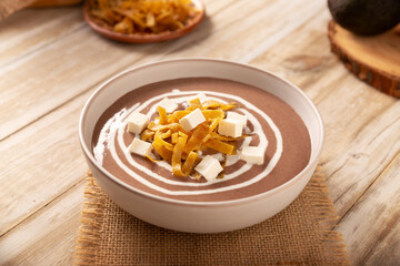 Creamy bean soup. In Mexico known as Crema de Frijoles, a very easy and nutritious homemade food recipe, commonly accompanied with cheese, cream, avocado and corn tortilla cut into strips and fried.