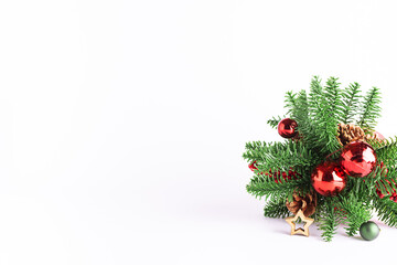 Bright Christmas and New year greeting card with decorated Christmas tree branches and shining decorations on white background close up, copy space for your text.