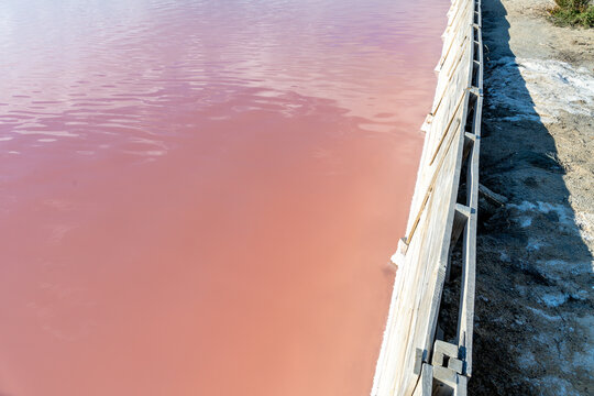 Vibrant Pink Salt Lake with Contrasting Sandy Landscape
