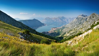 Fototapeta premium A grassy mountain slope rises to reveal the Adriatic Sea and distant coastline near the Bay_1(322)
