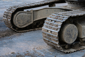 Heavy machinery track resting on a construction site in daylight