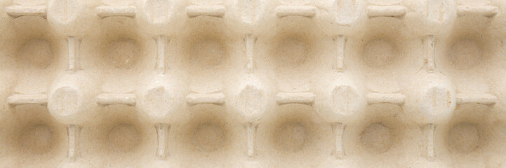 Empty new carton egg tray background. Closeup. Wide banner. Top down view.