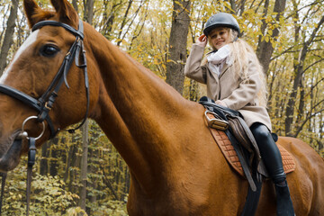 Fototapeta premium The girl is riding a horse. Horse riding club