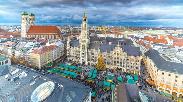 Munich Christmas MArket on Marienplatz main sqaure time lapse from day to night, munich skyline top view winter aerial view munich town hall cathedral church frauenkirche, munich marienplatz.