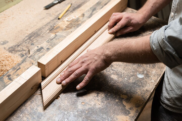 A carpenter is milling an oak part on a diy machine