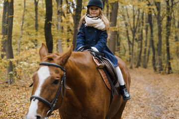 Fototapeta premium Young girl rides a horse in the forest.