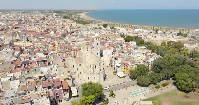Aerial view of the Basilica of Santa Maria Maggiore in the historic center of Barletta, Puglia, Italy. It is the cathedral and it was built in Romanesque style. In background is the Adriatic sea.