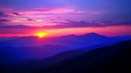 Fototapeta premium A vibrant sunset paints the sky above a mountain range, with the sun peeking over the horizon.