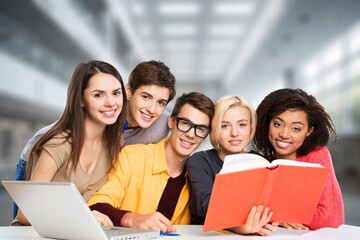 Diverse group of students studying at library.