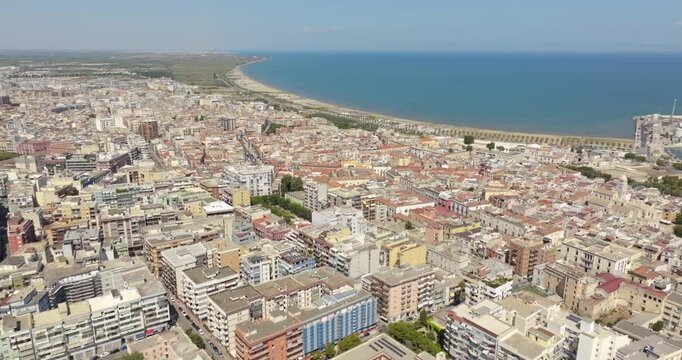 Aerial view of buildings, houses and apartments of Barletta, Puglia, Italy. In background is the beach on the Mediterranean sea.
