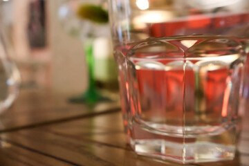 Close-up of a Glass with Red Liquid on a Wooden Table