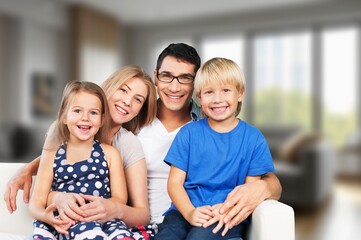 Happy young family with children at home.