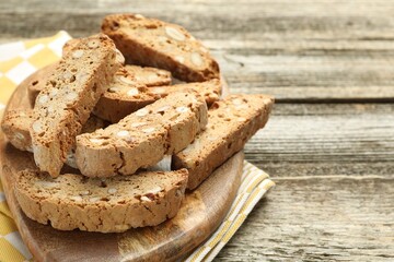 Traditional Italian almond biscuits (Cantucci) on wooden table, closeup. Space for text