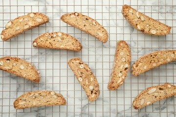 Traditional Italian almond biscuits (Cantucci) on white marble table, flat lay