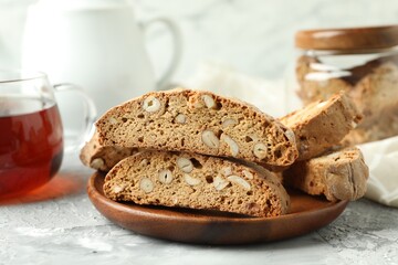 Traditional Italian almond biscuits (Cantucci) on grey textured table, closeup