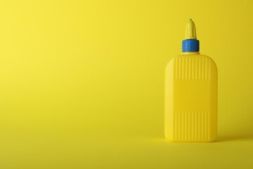 One bottle of glue on yellow background, space for text