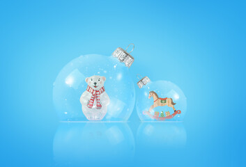 A Christmas card. Two transparent Christmas balls with toys on a blue background.