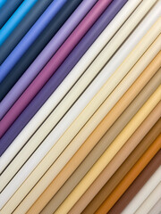 A row of different colored rolls of paper