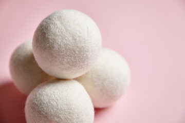 Stack of White Wool Dryer Balls on Pink Background