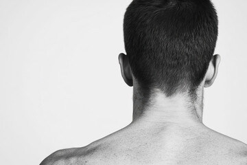 Black and White Photo of Man's Bare Back and Neck