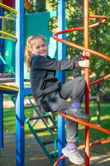 Fototapeta premium Cute beautiful smiling little girl on playground on sunny day