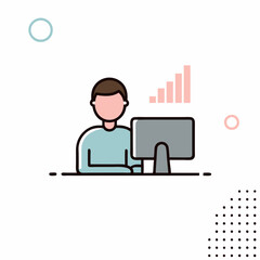 A man is sitting at a desk in front of a computer monitor. He is focused on his work and he is in a serious mood