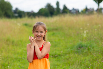 happy girl in a rainbow dress on the field