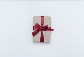gift box with a burgundy bow on a white background