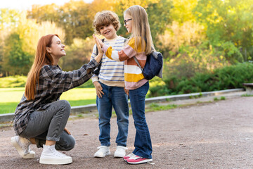 Children with their teacher in social gathering at park committed to teamwork