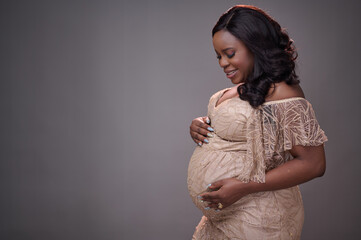 elegant maternity photoshoot featuring a glowing African mother-to-be dressed in a beautifully...