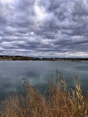 Autumn: a lake and beautiful low grey clouds above it