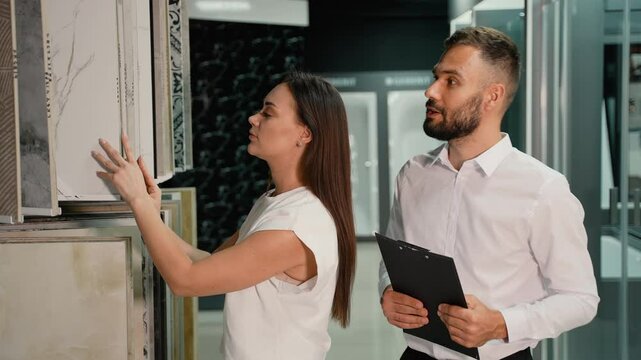 Woman Choosing Tile with Assistance from Showroom Consultant
