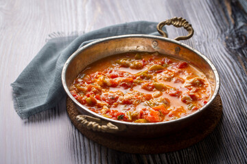 Famous Turkish menemen dinner on table, made by eggs, pepper and tomatoes.
