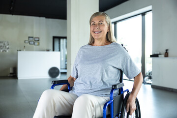 Woman in a grey tshirt sitting in a wheel-chair in a rehabilitation center