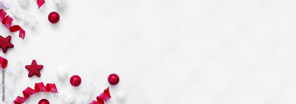 Poster christmas corner border of red and white baubles and curly ribbon. top down view on a white banner b