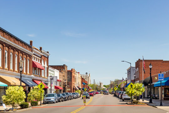 MOORESVILLE, NC, USA-17 APRIL 2022: Iconic, colorful wide-angle Main Street view on a sunny, blue sky, spring day.   Looking toward Bay State Milling Co.