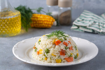 Delicious vegetable rice pilaf with green peas, carrots and sweet corn (Turkish name; sebzeli pilav)