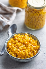 Canned sweet corn in bowl on kitchen table.