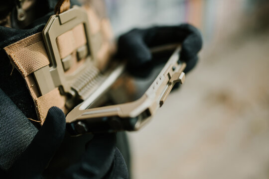 Soldier using rugged tablet in tactical vest - Powered by Adobe