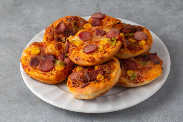Mini pizza with ham, olives and mozzarella - a delicious snack