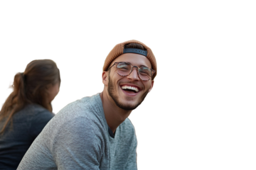 Smiling Young Man in a Beanie Enjoying a Sunny Day Outdoors With Friends at Sunset