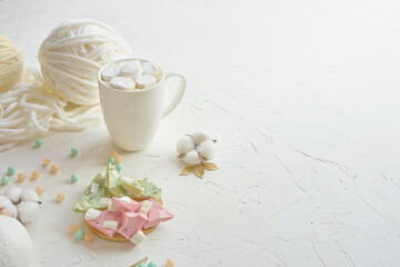 Savor a delicious hot chocolate with candies, marshmallows, and a touch of yarn for a cozy ambiance
