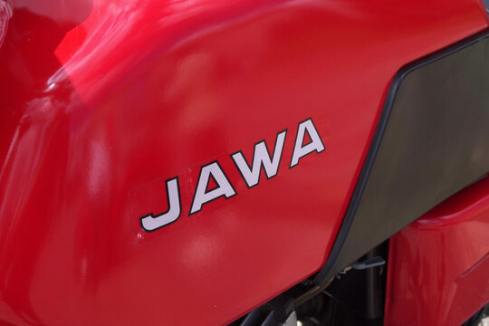 Oryol, Russia - August 03, 2024: Side of red motorcycle with word  JAWA written on it. Motorcycle is parked outdoors