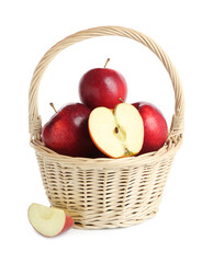Fresh ripe red apples in wicker basket isolated on white