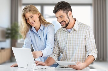 Obraz premium Couple reading with laptop documents for pay tax