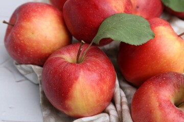Whole ripe red apples on white table, closeup